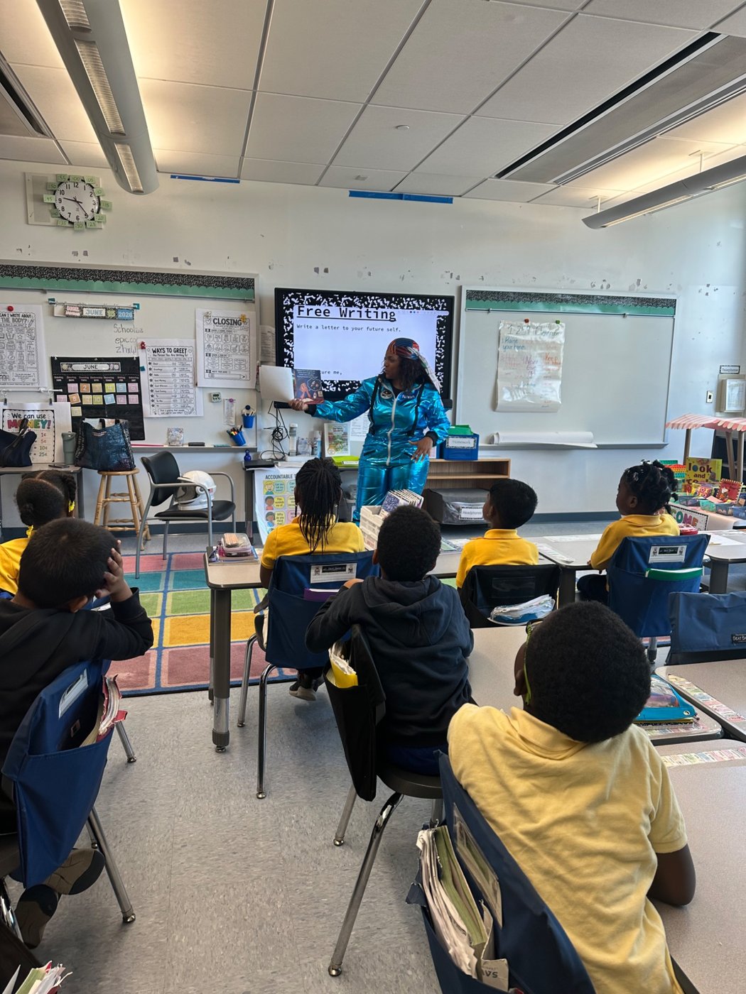 Students attending a storytelling visit at Queens Elementary School